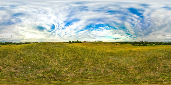 Sunset or sunrise in the green field with blue sky. Image with 3D spherical panorama with 360 viewing angle. Ready for virtual reality or VR. Full equirectangular projection. Green grass. Hills. — Stock Photo, Image