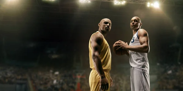 Basketball players on big professional arena before the game. Two teams. Players collided face to face. Player holds a ball