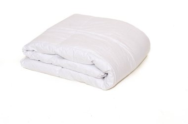 Rolled white duvet cover on  isolated background clipart