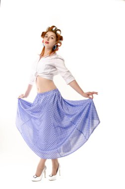 Redheaded girl in hair curlers in lilac skirt, a white topography and isolated on a white background
