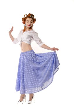 Redheaded girl in hair curlers in lilac skirt, a white topography and isolated on a white background