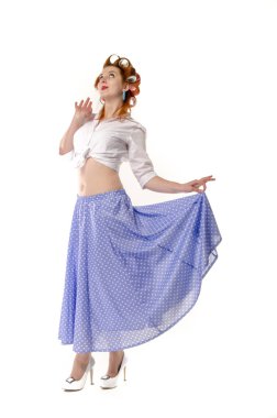 Redheaded girl in hair curlers in lilac skirt, a white topography and isolated on a white background