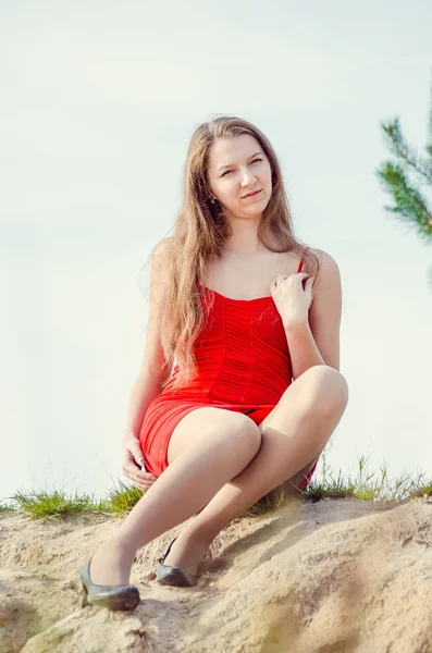 Mladá žena v červených šatech příroda čerstvý vzduch — Stock fotografie