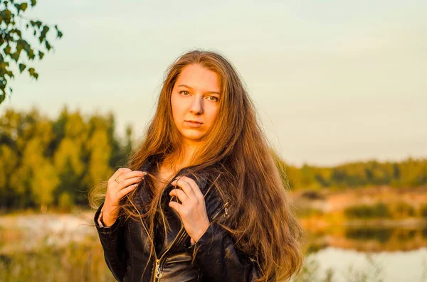 Beautiful girl in a posh red dress posing on a poppy field. Poppy field at sunset. Art processing. Sunset — Stock Photo, Image