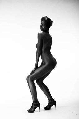 Çıplak kadın stüdyoda beyaz bir arka plan üzerinde siyah boyalı