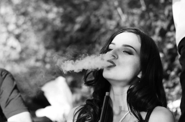 Sexy girl with smartphone smokes hookah — Stock Photo, Image