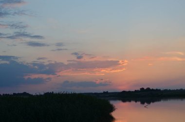Gün batımında çimenler nehir manzarasında