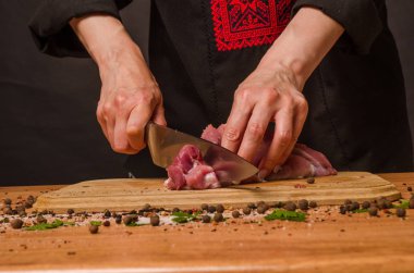 Onların elinde bir bıçak ile eller taze et bir masaya kesilmiş.