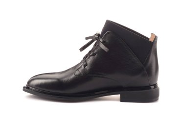 Klasik siyah ve beyaz spor ayakkabı kadın bacaklar. Bacakları yukarı doğru kaldırdı ve yan yana sarkıtmak. Gri arka plan. Klasik ayakkabılar. Sağlıklı yaşam tarzı