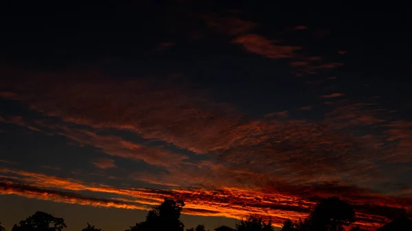Hemelsblauw en oranje licht van de zon door de wolken aan de hemel — Stockfoto