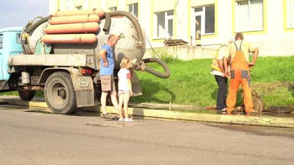 Trabajador de alcantarillado en tubería de limpieza de la calle, buzo de reparación de alcantarillado Lutsk Ucrania 08 / 01 / 2018 — Foto de Stock