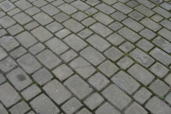 Pavimento de pedra em perspectiva. Textura do pavimento de pedra. Granito calçada fundo pavimento. Fundo abstrato de um pavimento de paralelepípedo close-up — Fotografia de Stock