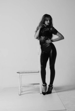 Çekici esmer güzellik sandalyede oturuyor.