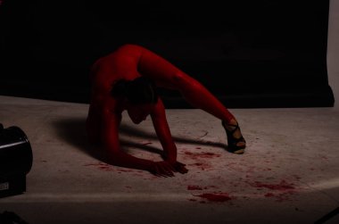 genç bir kızın yaratıcı portresi. Yüz kırmızı glitter boya ile boyanmıştır. Üçgen yüze çizilir. Siyah arka plan daki profilmodeli