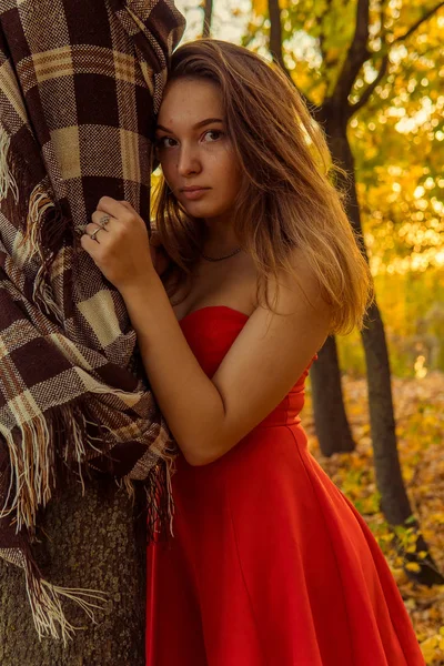 Una donna posa davanti a una telecamera in un parco autunnale. servizio fotografico d'autunno. Autunno nel parco . — Foto Stock