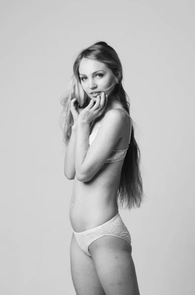 portrait of exquisite woman in lingerie sitting.