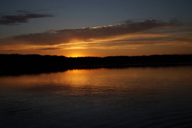 Sabahın erken saatlerinde gölün üzerinde sonsuz karanlık gökyüzü manzarası.   