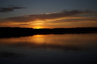 Sabahın erken saatlerinde gölün üzerinde sonsuz karanlık gökyüzü manzarası.   