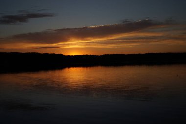 Sabahın erken saatlerinde gölün üzerinde sonsuz karanlık gökyüzü manzarası.   
