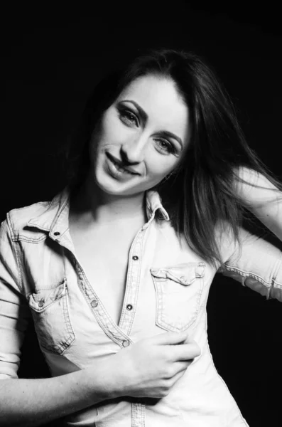 beautiful woman with sort hair posing on dark background