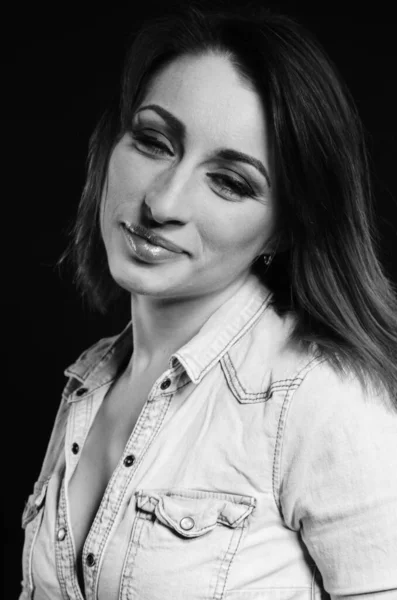 beautiful woman with sort hair posing on dark background