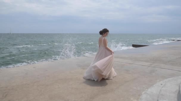 穿晚礼服的女孩在海边旋转 — 图库视频影像