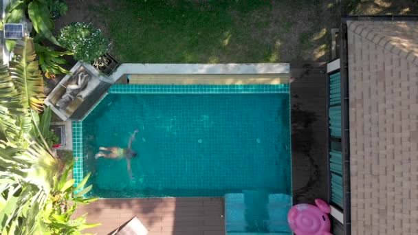 Mädchen Auf Rosa Flamingo Schwimmt Pool — Stockvideo