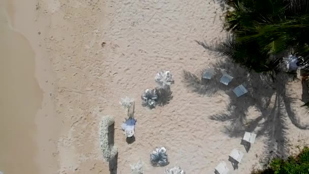 Ocean beach wedding decorations shot from the sky — Stock Video