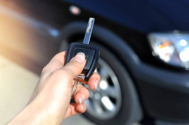 Düğme uzaktan araba üzerinde tutan el. Kadın seçici odak içinde el uzaktan kumanda araba alarm sistemleri üzerinde baskı. Otomatik sigorta iş. Araba güvenlik kilit sistemi kavramı.