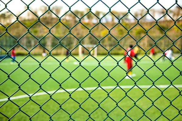 A Beautiful Football Playground From Outside Fence ,Football ground, Green fence, close shot, sports,football players