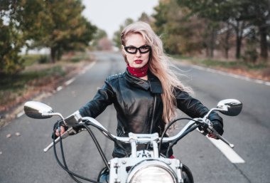 Açık yol üzerinde motosiklet ile poz güzel motorcu kadın.