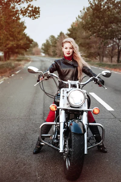 美しいバイクに乗る女性がオートバイの道路上で屋外ポーズ — ストック写真