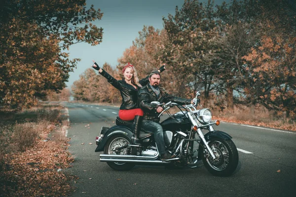 Motosiklet ile poz mutlu bisikletciler.