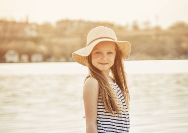 Sevimli küçük kız gün batımında sahilde bir eğlence var.