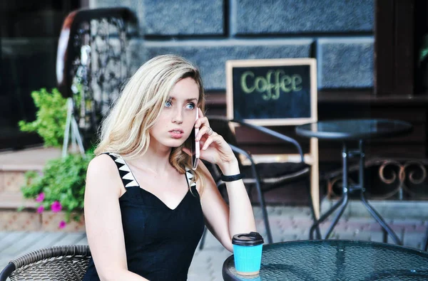 コーヒーハウスでコーヒーの紙カップを持つ美しい若い女性 — ストック写真