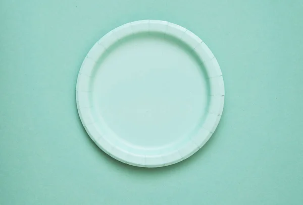 Colorful paper plates on light background.