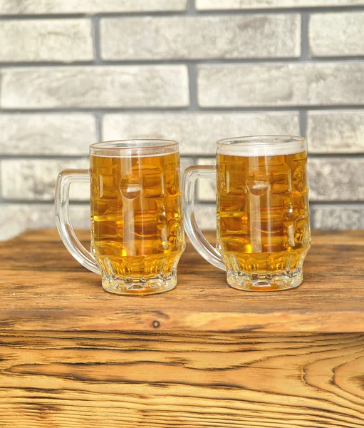 Two glasses of light beer on wooden table. Oktoberfest concept.