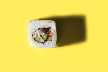 Japon suşisi sarı arka planda sert ışıkla.