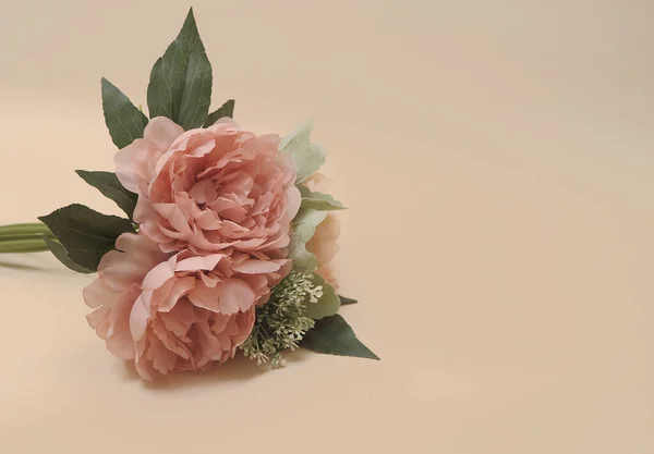 artificial flowers  on beige background