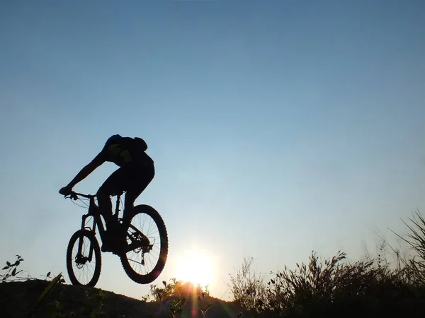 silhouette in sunrise mountain bike