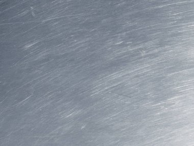 Paslanmaz çelik dokusu ile dairesel çizik.