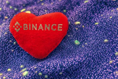 cryptocurrency binance altın bir neon arka plan ile kırmızı bir artı işareti kalp sembolüdür. BnB