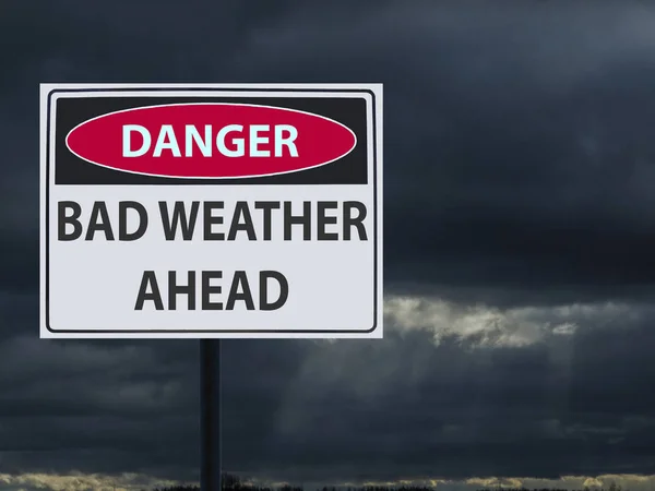 sign dangerous bad weather ahed and dark clouds of snow and rain