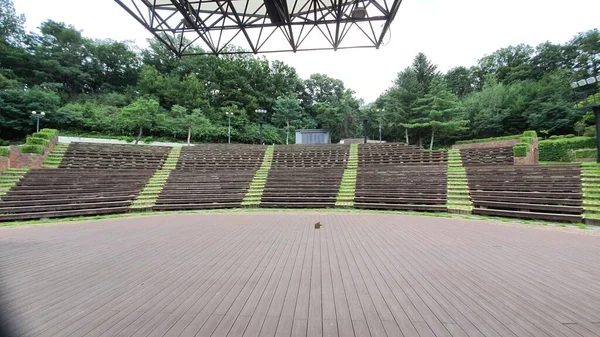 an outdoor performance hall and audience