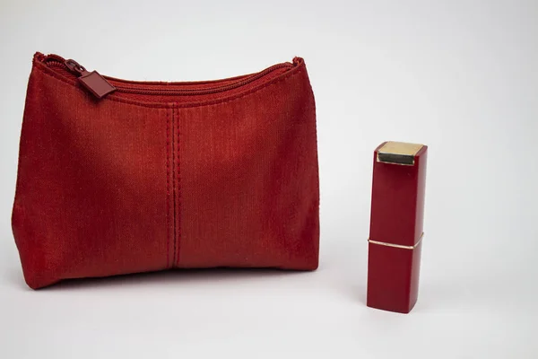 Red bag, bag design, red cosmetic bag with red lipstick, place for text, isolate