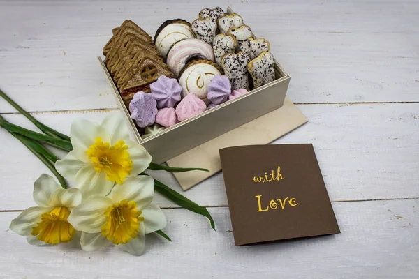 Box of sweets on a white background. with flowers. Box of cookies for Valentine\'s Day. With love. copy space