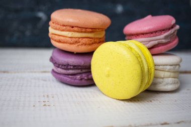 Rengarenk makaronlar üst üste yığılmış. Bademli kurabiye üzerinde