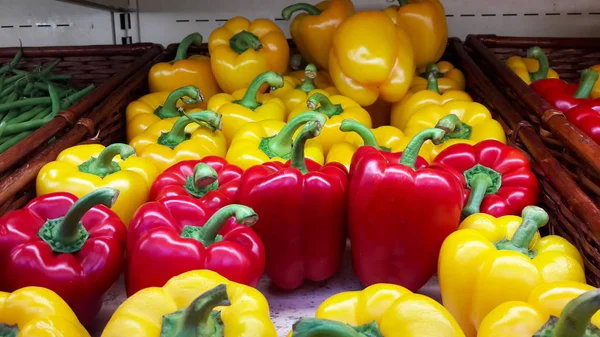 Background red pepper and yellow pepper. Fresh ripe red and yell