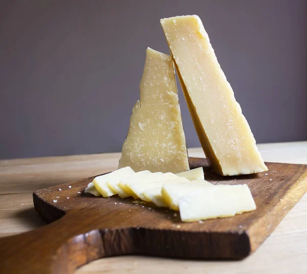 Wooden table with parmesan cheese. Food. Healthy food. Wooden bo