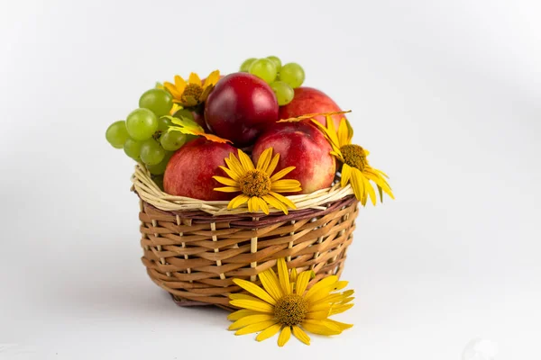 Fresh fruits. Healthy food. Mixed fruit, peaches and grapes. Studio photography of various fruits on an old wooden table. Organic healthy assorted fruits. Fruit in a basket. Fruit food background.